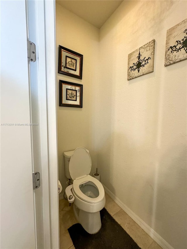 bathroom featuring toilet and tile patterned floors