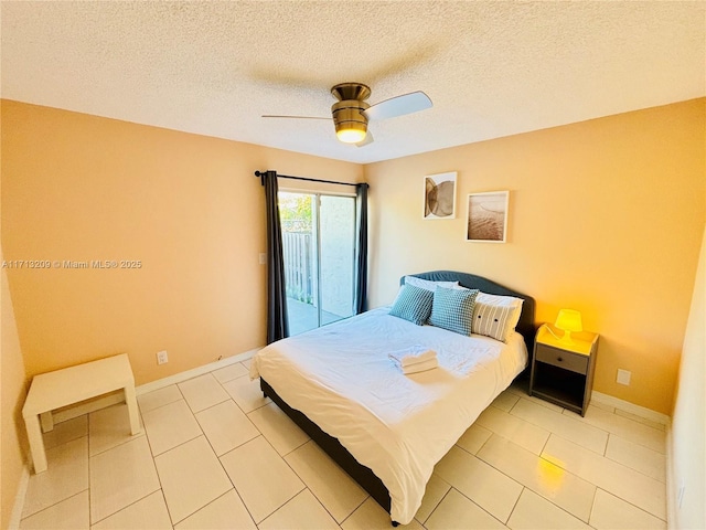 bedroom with a textured ceiling, ceiling fan, and light tile patterned floors