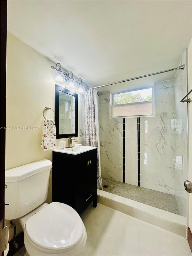 bathroom featuring vanity, toilet, and walk in shower