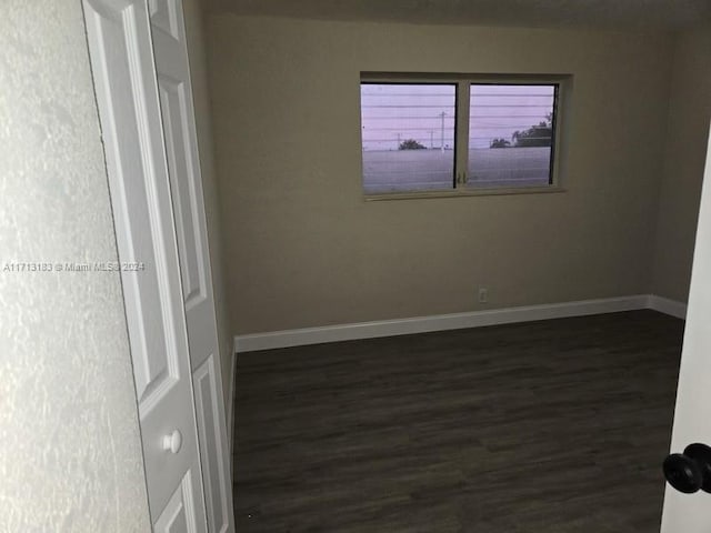 spare room featuring dark hardwood / wood-style flooring