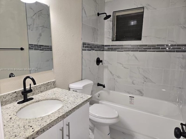 full bathroom featuring tiled shower / bath, vanity, and toilet