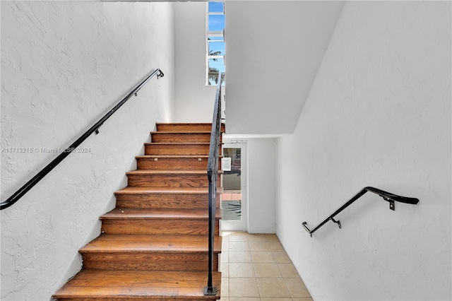 stairway featuring tile patterned floors