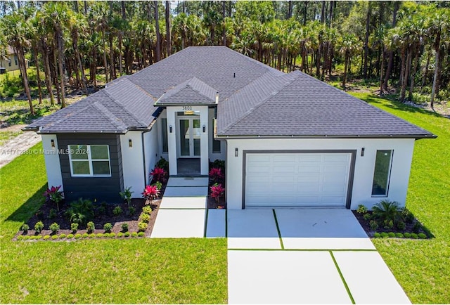 view of front of property featuring a garage and a front lawn