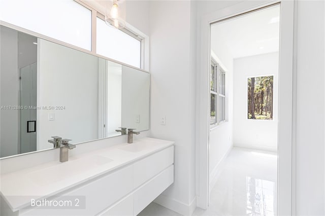 bathroom with vanity and a shower with shower door