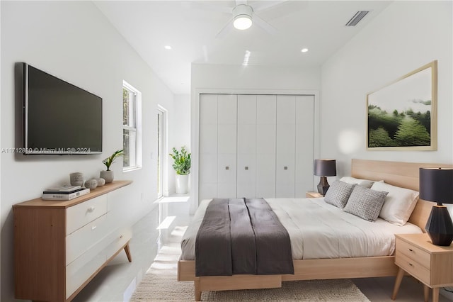 bedroom with ceiling fan and a closet