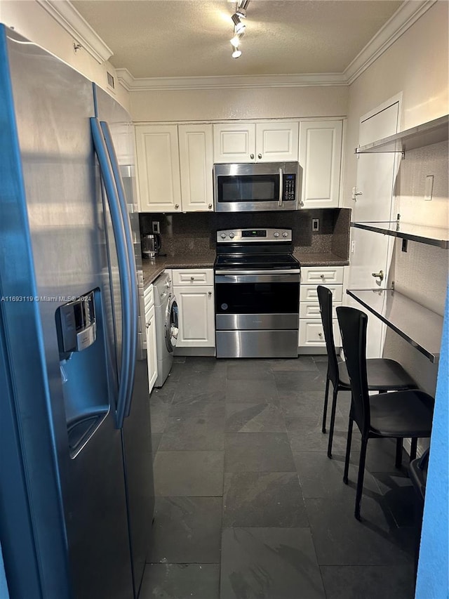 kitchen with washer / dryer, white cabinetry, crown molding, and appliances with stainless steel finishes