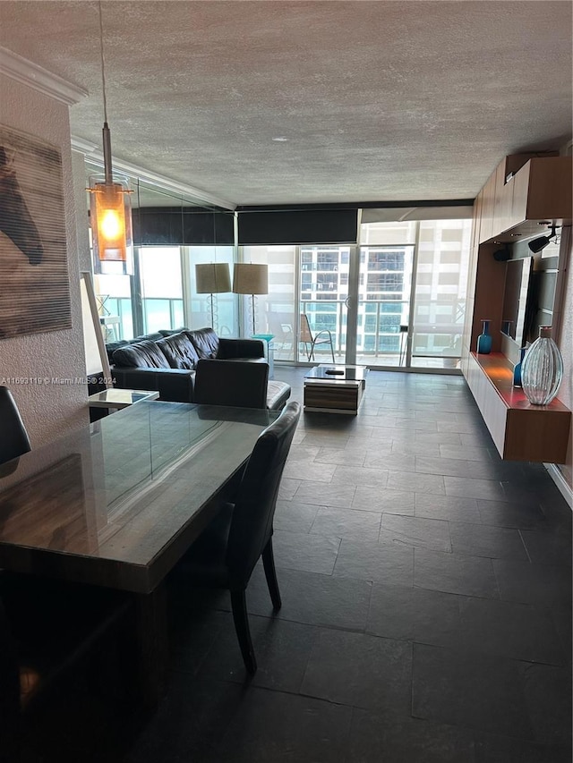 dining area with expansive windows and a textured ceiling