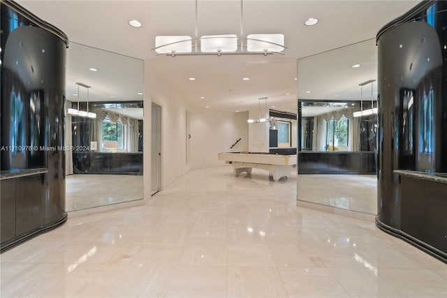 hall featuring light tile patterned floors