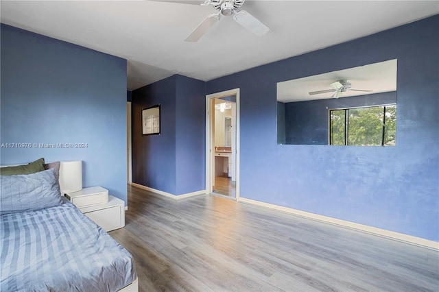 unfurnished bedroom featuring hardwood / wood-style floors and ceiling fan