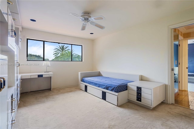 bedroom featuring ceiling fan and light colored carpet