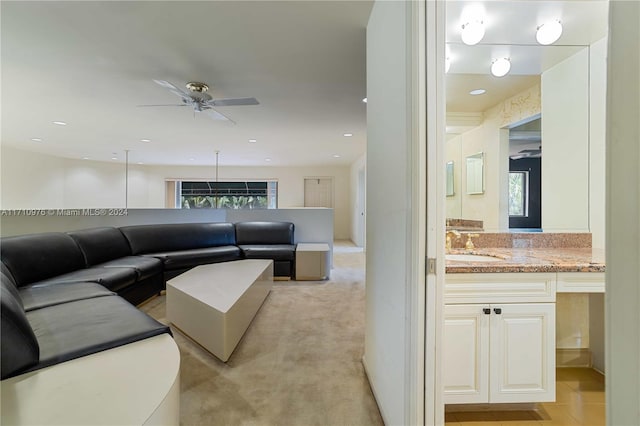 carpeted living room featuring sink, a wealth of natural light, and ceiling fan