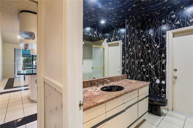 bathroom with tile patterned flooring, vanity, and toilet