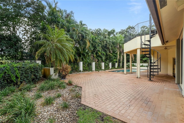 view of patio with a balcony and a fenced in pool