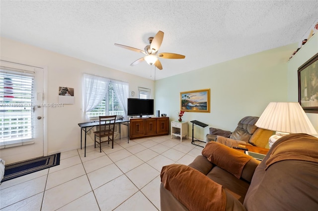 tiled living room with a textured ceiling and ceiling fan