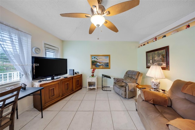 tiled living room featuring a textured ceiling and ceiling fan