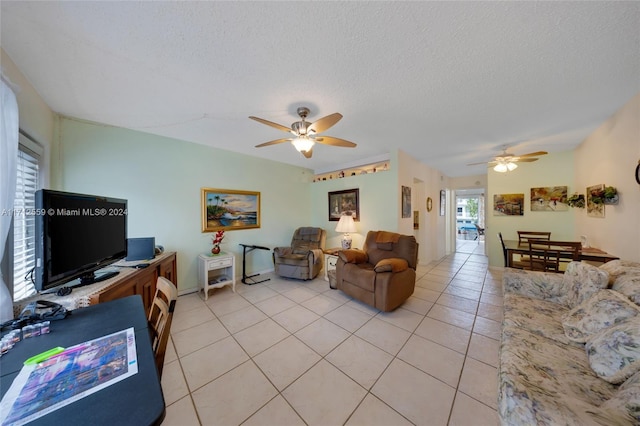 tiled living room featuring ceiling fan and a textured ceiling