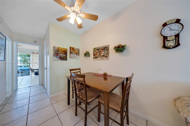 tiled dining area with ceiling fan