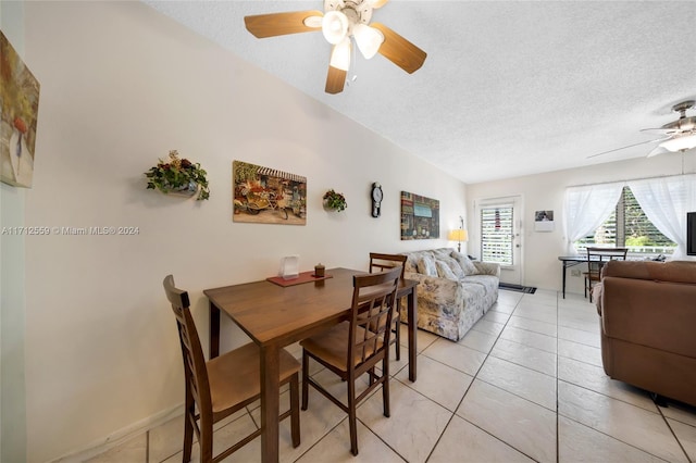 dining room featuring ceiling fan, light tile patterned flooring, and a textured ceiling