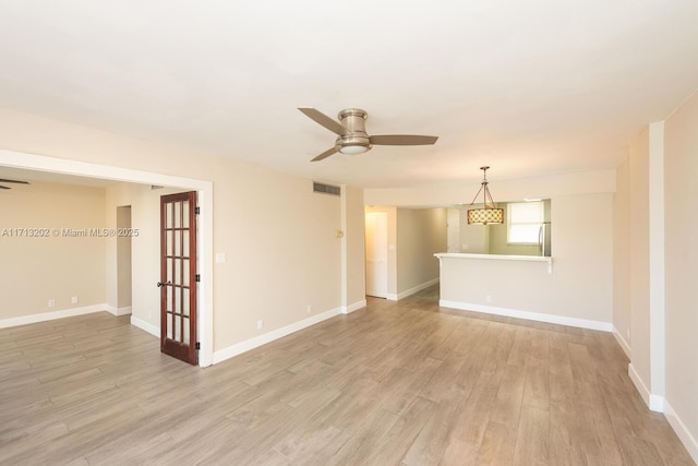 empty room with ceiling fan and light wood-type flooring