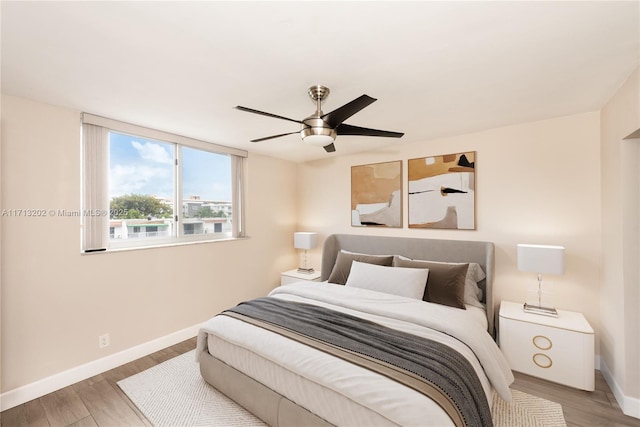 bedroom with hardwood / wood-style flooring and ceiling fan