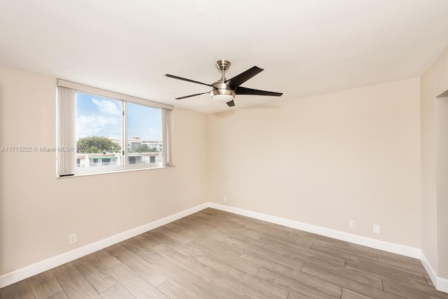 spare room with hardwood / wood-style floors and ceiling fan