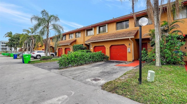 multi unit property featuring a garage