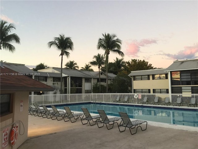 view of pool at dusk