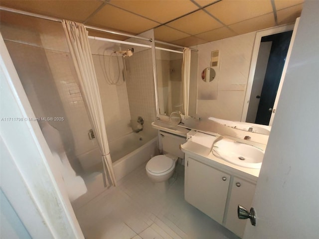 full bathroom with shower / bath combo, a paneled ceiling, vanity, tile patterned flooring, and toilet