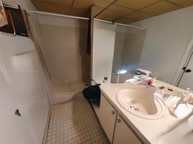 bathroom featuring tile patterned flooring, a shower, and vanity