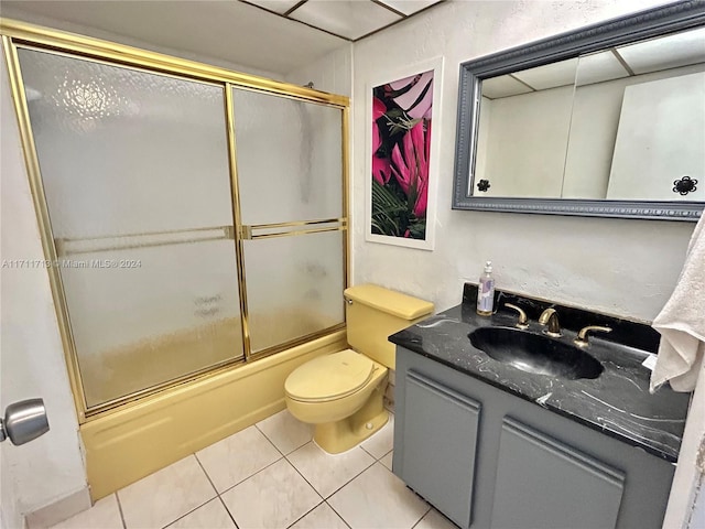 full bathroom with tile patterned floors, vanity, toilet, and shower / bath combination with glass door