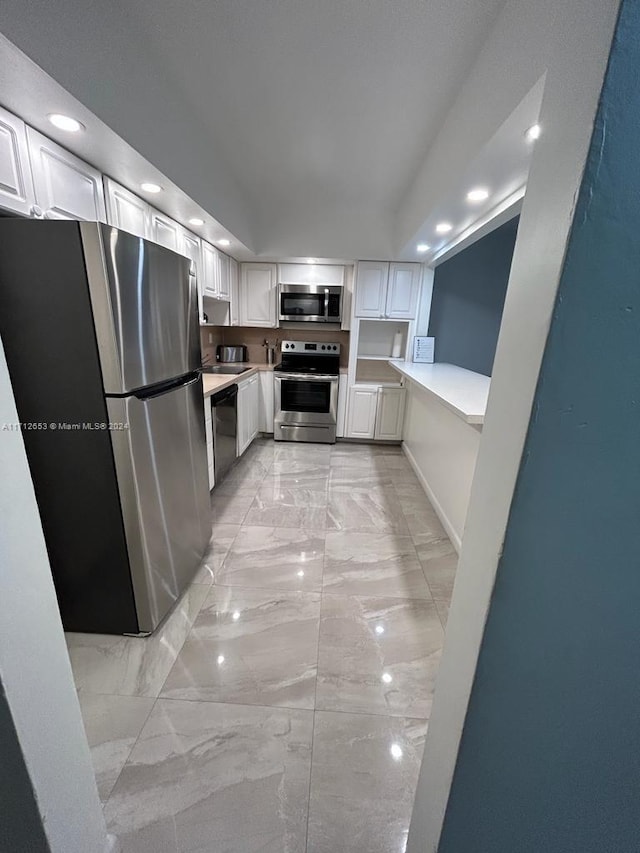 kitchen featuring white cabinets and appliances with stainless steel finishes