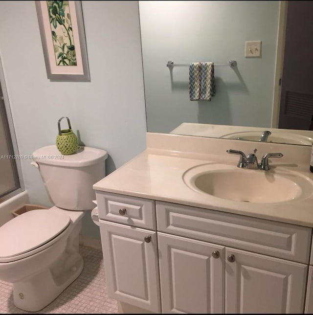 bathroom with tile patterned floors, vanity, an enclosed shower, and toilet