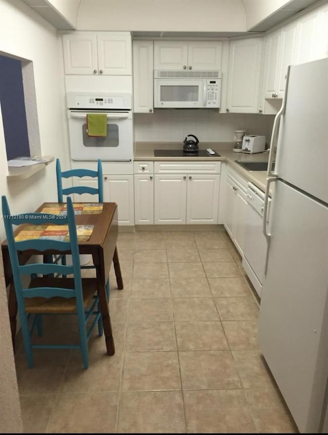 kitchen featuring white cabinets, white appliances, and light tile patterned floors