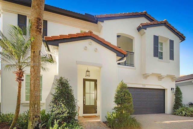 mediterranean / spanish home with a garage and a balcony