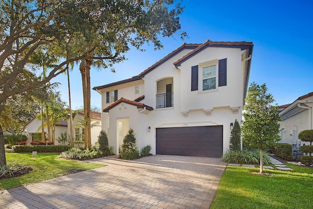 mediterranean / spanish-style home featuring a balcony, a front lawn, and a garage