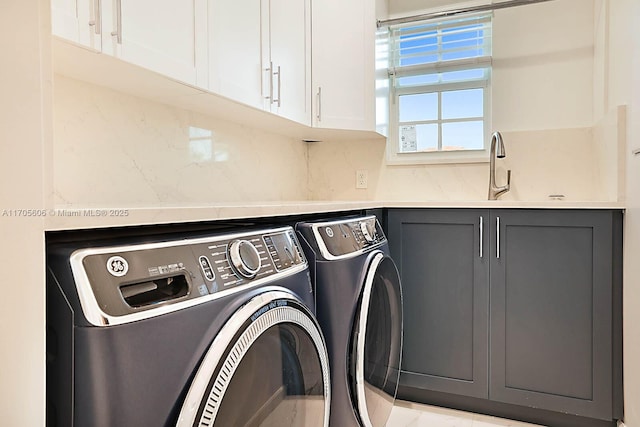 laundry area with cabinets, separate washer and dryer, and sink