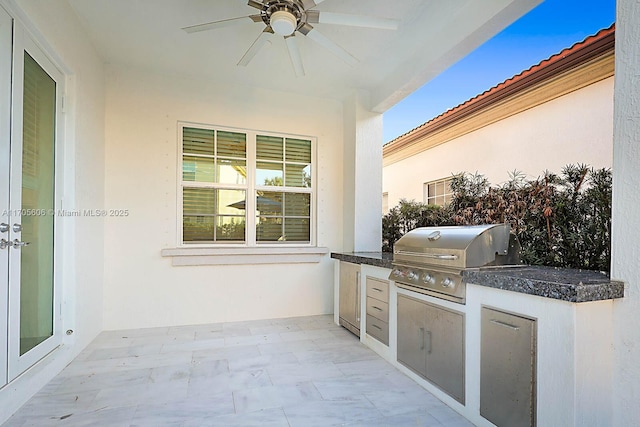 view of patio featuring a grill, ceiling fan, and exterior kitchen