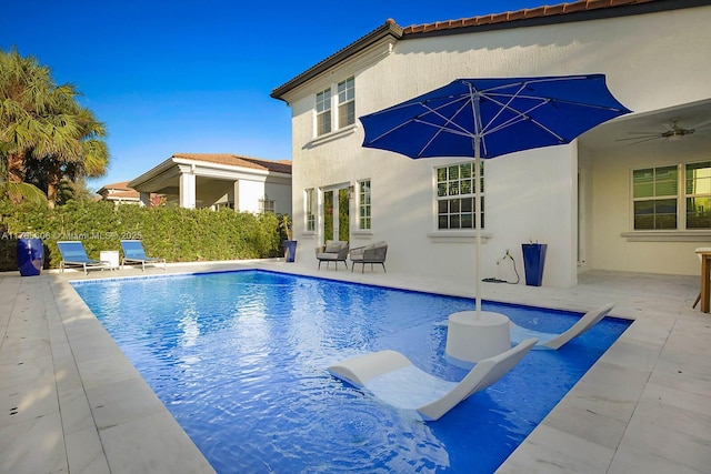 view of pool featuring ceiling fan and a patio