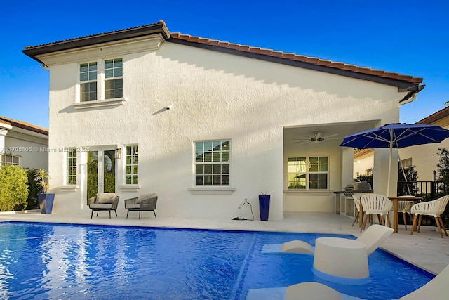 back of house featuring ceiling fan, area for grilling, and a patio