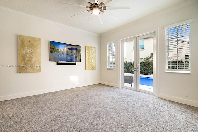 spare room with carpet flooring, ceiling fan, french doors, a textured ceiling, and ornamental molding