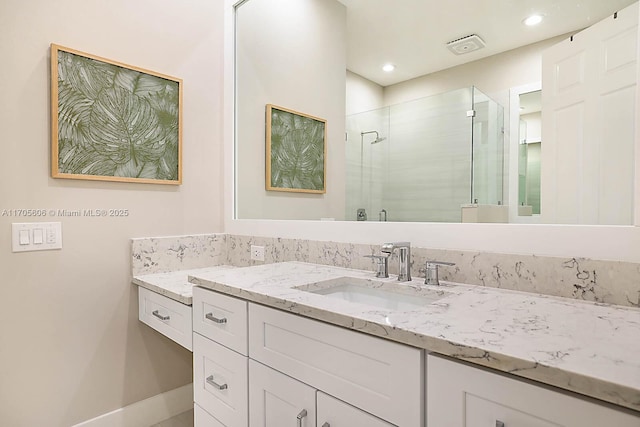 bathroom with vanity and an enclosed shower