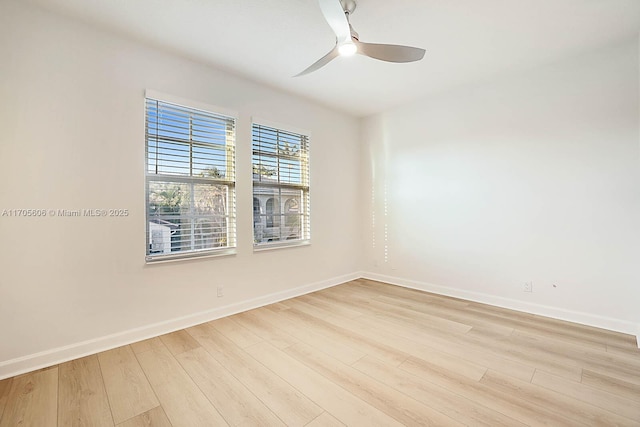 empty room with ceiling fan and light hardwood / wood-style flooring