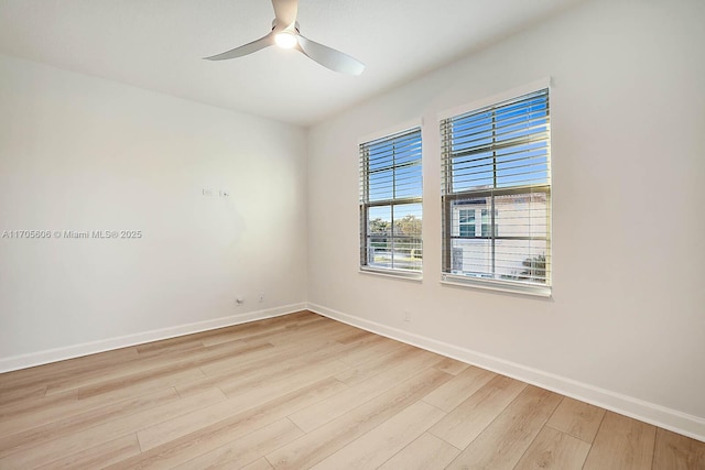 spare room with ceiling fan and light wood-type flooring