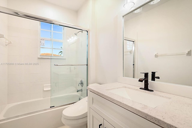 full bathroom featuring vanity, toilet, and enclosed tub / shower combo