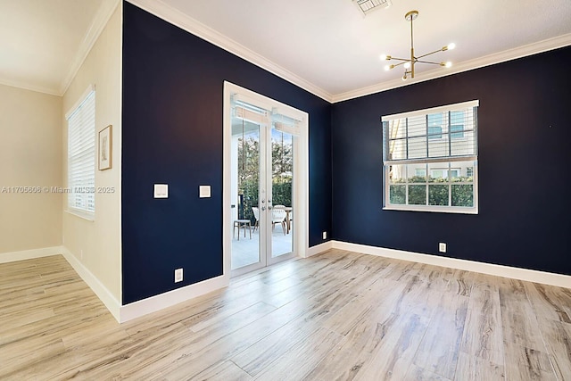 foyer entrance with a notable chandelier, a healthy amount of sunlight, light hardwood / wood-style floors, and ornamental molding