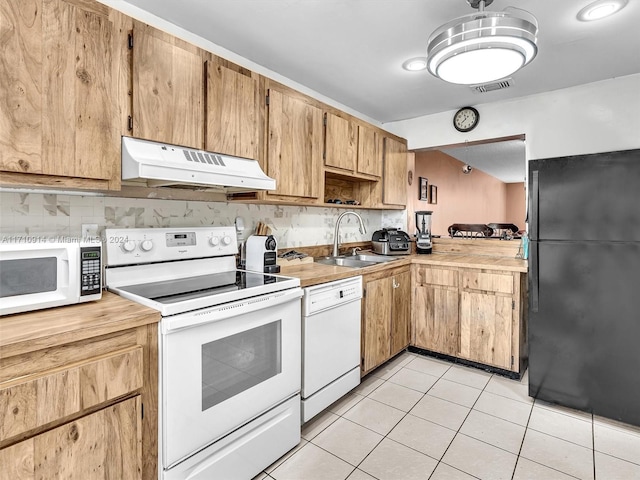 kitchen with white appliances, visible vents, light countertops, under cabinet range hood, and a sink