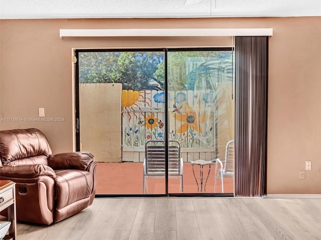 entryway featuring light wood-style floors and a textured ceiling