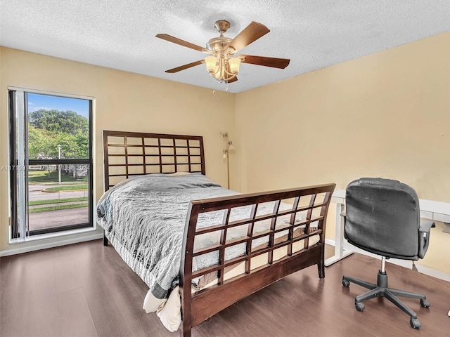 bedroom featuring a textured ceiling, ceiling fan, and wood finished floors