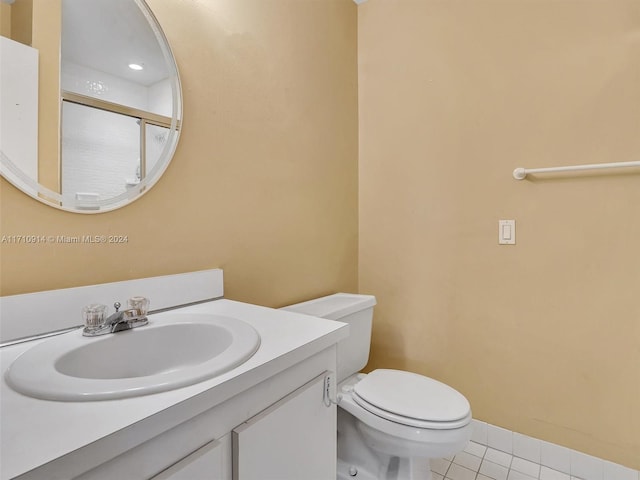 bathroom featuring tile patterned flooring, vanity, and toilet