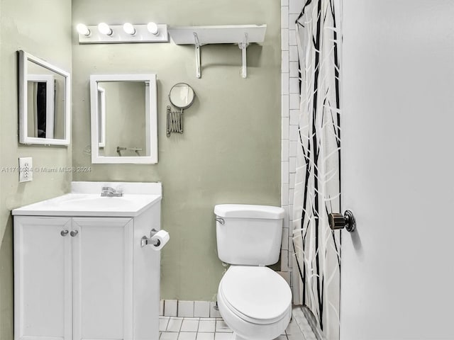 bathroom featuring toilet, curtained shower, tile patterned flooring, and vanity